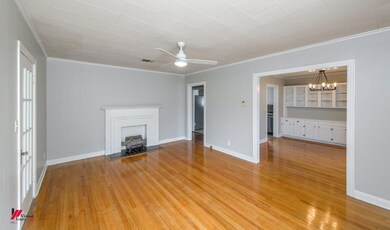 Unfurnished living room featuring ceiling fan with