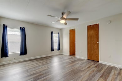 Primary bedroom with doors to bathroom and walk-in closet