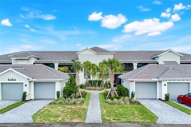 Traditional-style home featuring a tiled roof and stucco siding