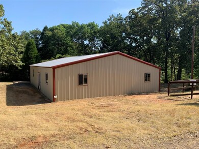 View of outbuilding with a yard