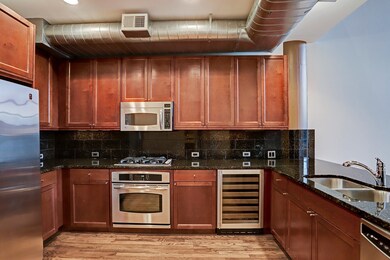 The Kitchen is open to the Living/Dining areas and boasts abundant cabinets, stainless appliance package, gas cooktop and slab granite countertops.