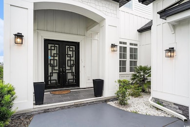 Entrance to property featuring board and batten si