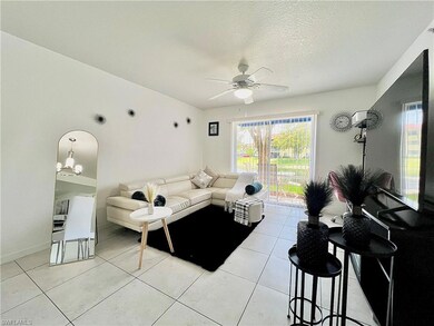 Living room featuring ceiling fan with notable cha