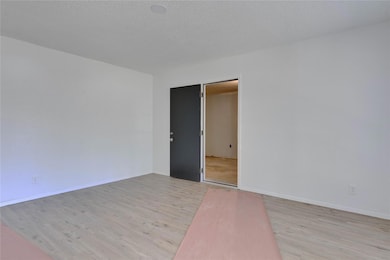Spare room with light wood-type flooring, baseboa