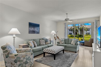 Living room with ceiling fan and light wood-type f