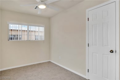 Empty room featuring a ceiling fan, baseboards, an