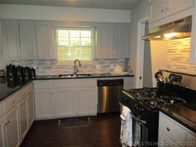 Kitchen With Granite And Gas Range