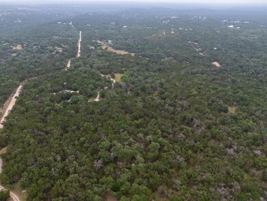 View of property location featuring a forest