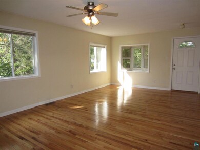 offers a bay window and gleaming hardwood floors.