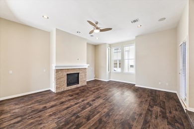 Spacious living room anchored by a gas log fireplace.
