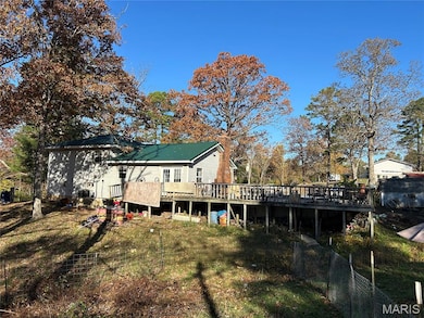 Back of house featuring a wooden deck