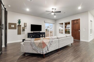 Living room featuring a barn door, dark wood-styl