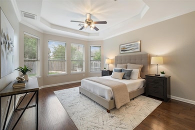 Bedroom featuring visible vents, wood-type floori