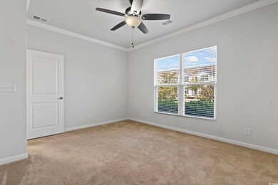 Spare room with light carpet, crown molding, and c