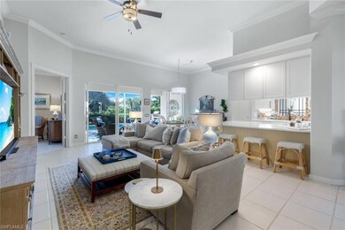 Living room featuring ceiling fan, light tile patt