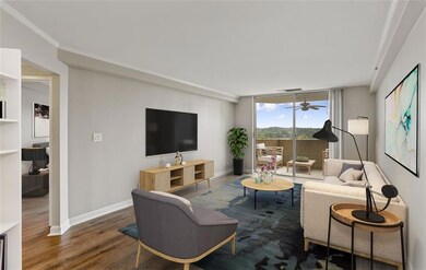 Living room featuring ornamental molding, hardwood
