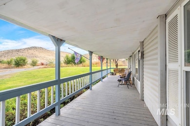 Porch featuring a lawn and a mountain view