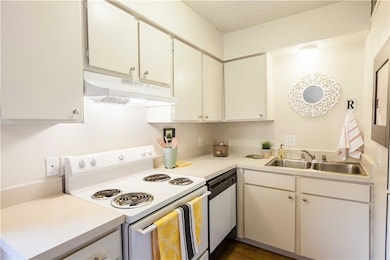 Kitchen featuring white range with electric cookt