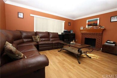 Living Room with Laminate Wood Flooring, Crown Mol