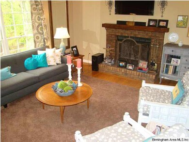 Family room/den has wood burning fireplace and ton