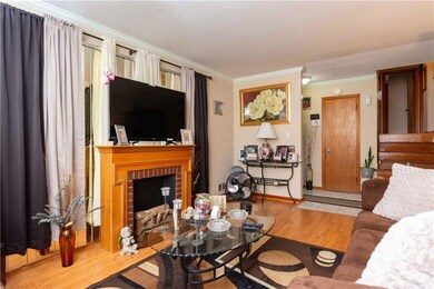 Living room with ornamental molding, a fireplace, 