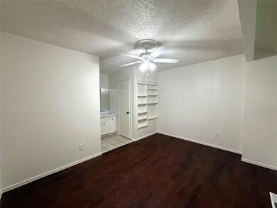 Spare room with wood finished floors, ceiling fan