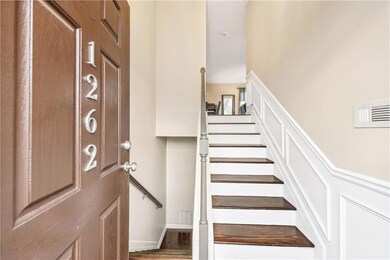 Staircase featuring a high ceiling, visible vents,