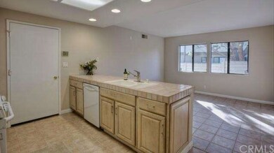 A center island in the kitchen opens to a family r