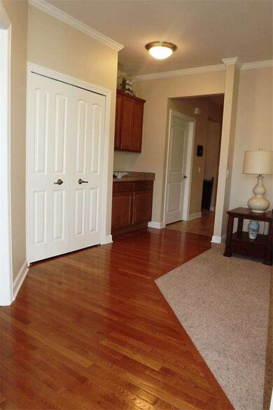 Inside the front door, there is gorgeous hardwood 