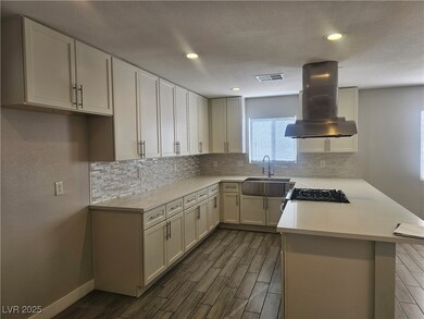 Kitchen with visible vents, light countertops, whi