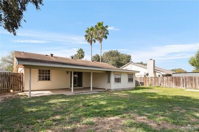 Back of property with a fenced backyard, a lawn, and a patio area