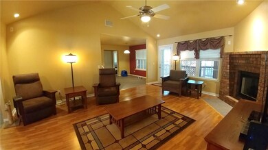 Living room has vaulted ceilings and has a door that leads out to spacious covered deck.