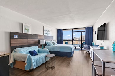 Bedroom with floor to ceiling windows, a textured 