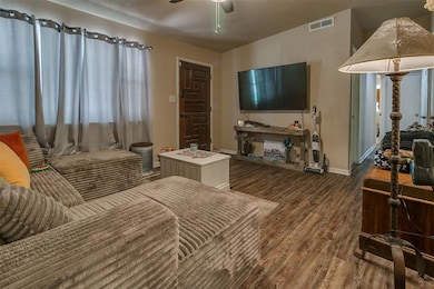 Living room with wood finished floors and a ceiling fan