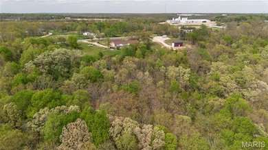 Aerial view featuring a forest view