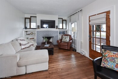 Living room with a fireplace and dark hardwood / wood-style flooring