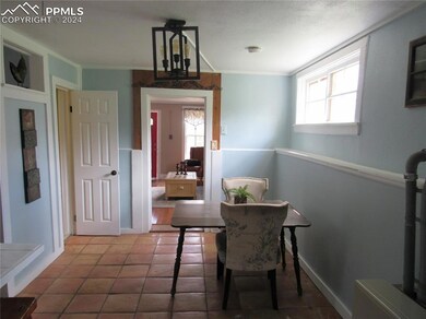 Dining space with a chandelier, ornamental molding