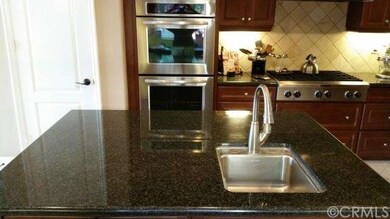 Expansive granite island includes 1 of 3 sinks in 