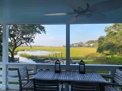 Wooden terrace featuring ceiling fan, a water view