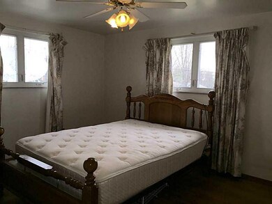 Bedroom. Ceiling fan with light and neutral walls