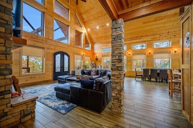 Living room with beamed ceiling, wood-type floorin