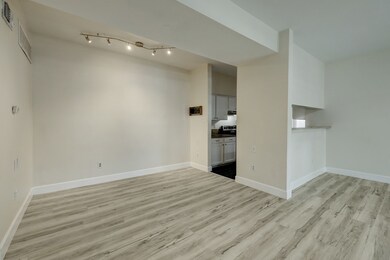 Bright, open living space with light wood flooring