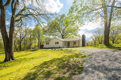 View of front of house with a front yard and a chi