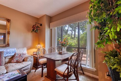 Dining area featuring light colored carpet and plenty of natural light