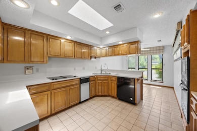 Kitchen with visible vents, a peninsula, light co