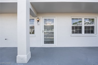 View of exterior entry with stucco siding and a pa