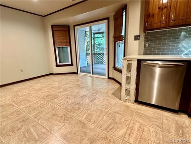 Kitchen featuring backsplash, crown molding, light