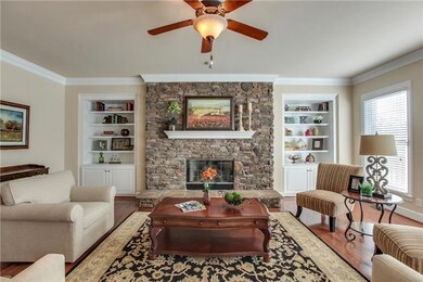 Family room with built-ins, lots of natural light and rock fireplace with gas logs........