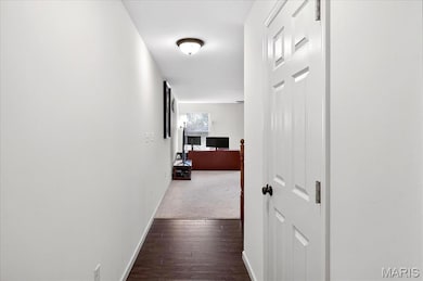 Hall with baseboards and dark wood-style floors