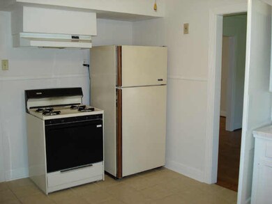 Spacious kitchen with gas stove and refrigerator